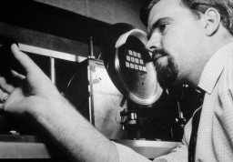 Photo of Trevor Davies aligning optical fibre experiment